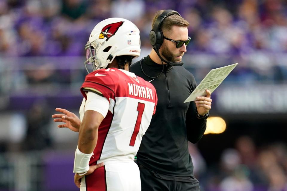 Arizona Cardinals head coach Kliff Kingsbury talks with quarterback Kyler Murray (1) during the second half of an NFL football game against the Minnesota Vikings, Sunday, Oct. 30, 2022, in Minneapolis. (AP Photo/Abbie Parr)