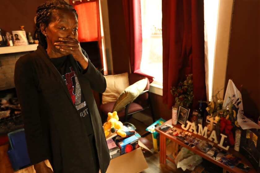 PASADENA, CA - DECEMBER 22, 2021 - - Lisa Lewis mourns the loss of her son, Jamal Patterson, near a makeshift memorial in her home in Pasadena on December 22, 2021. Patterson was shot and killed down the street from his mother's home on Oct. 25, 2021. "That's what I say to Pasadena. "There are too many guns out here," said Lewis. "There should be no more bloodshed in the neighborhood," she concluded. Patterson was sitting in a car with two other men when someone shot at the car. Patterson was shot in the head and when Lewis got to Huntington Memorial Hospital he was braindead. He died three days later. Lewis is a homeowner in northwest Pasadena, where many of the shootings have taken place over the last year. A 16-year-old boy was arrested last month in connection to the shooting and charged with murder. (Genaro Molina / Los Angeles Times)