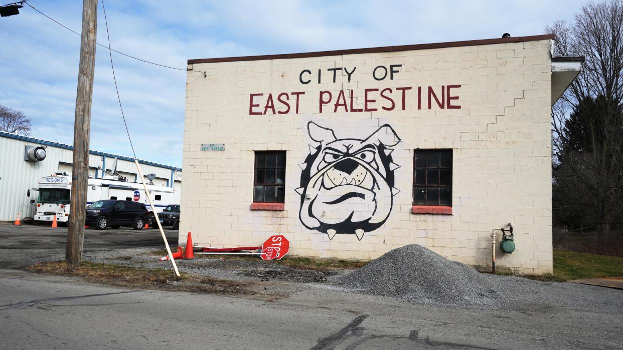 The East Palestine High School mascot, the bulldog, is painted on the front of the East Palestine city garage. Tucked in next to another garage is the Environmental Protection Agency Region 5 bus.  A Feb. 3 train derailment has had toxic ramifications for the Columbiana County community. Attorneys Tom Bevan, Mikal Watts and Alicia O'Neill also attended. 