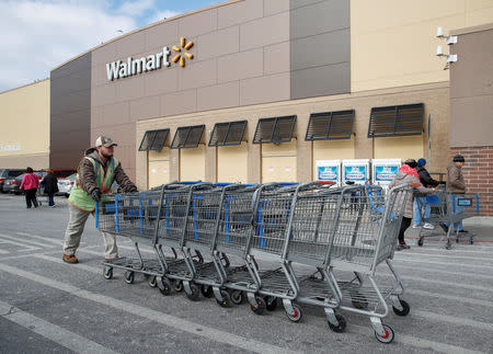 An employee pushes shopping carts outside a Walmart store in Chicago, Illinois, U.S., November 20, 2018. REUTERS/Kamil Krzaczynski