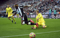 Brentford's Mads Roerslev, right, tackles Newcastle United's Allan Saint-Maximin for the ball during the English Premier League soccer match between Newcastle United and Brentford at St. James' Park, Newcastle, England, Saturday Nov. 20, 2021. (Owen Humphreys/PA via AP)