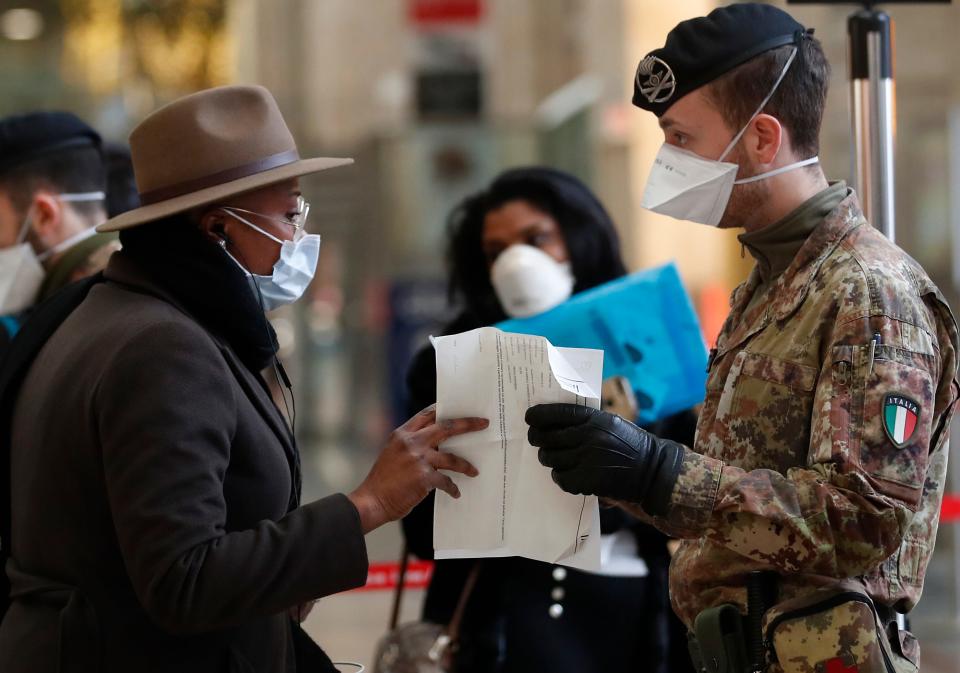 Police officers and soldiers check passengers leaving from Milan main train station, Italy, Monday, March 9, 2020. Italy took a page from China's playbook Sunday, attempting to lock down 16 million people — more than a quarter of its population — for nearly a month to halt the relentless march of the new coronavirus across Europe. Italian Premier Giuseppe Conte signed a quarantine decree early Sunday for the country's prosperous north. Areas under lockdown include Milan, Italy's financial hub and the main city in Lombardy, and Venice, the main city in the neighboring Veneto region. (AP Photo/Antonio Calanni)