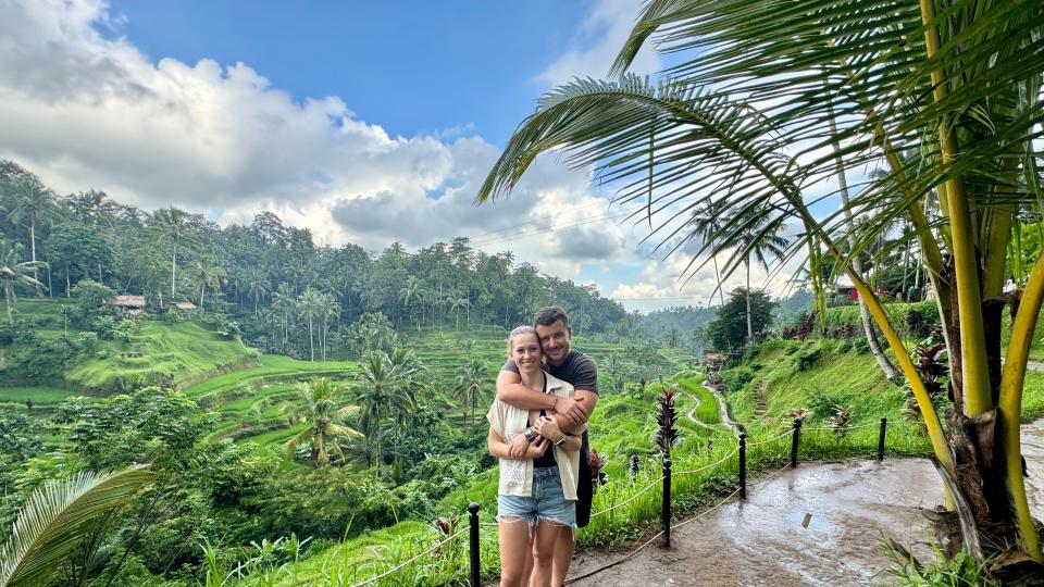 Lucas Frischmann with his wife posing in a tropical forest.