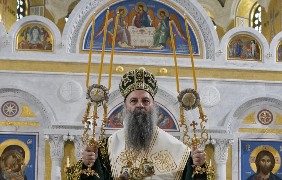 FILE - Serbian Orthodox Church Patriarch Porfirije performs the traditional Divine Liturgy in the St. Sava temple in Belgrade, Serbia, Friday, Jan. 7, 2022. The head of the Serbian Orthodox Church Patriarch Porfirije has tested positive for the coronavirus, the church said on Tuesday, Jan. 11, 2022, amid a surge in infections in the country and elsewhere in the Balkan region. The 60-year-old patriarch became the head of the Serbian Orthodox Chruch after the previous patriarch, Irinej, died in Nov. 2020 after contracting the coronavirus. (AP Photo/Darko Vojinovic, File)