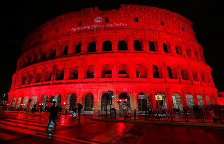 The Colosseum is lit up in red to draw attention to the persecution of Christians around the world in Rome, Italy, February 24, 2018. REUTERS/Remo Casilli