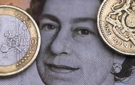 A two Euro coin is pictured next to a one Pound coin on top of a portrait of Britain's Queen Elizabeth in this file photo illustration shot March 16, 2016. REUTERS/Phil Noble/Illustration/Files