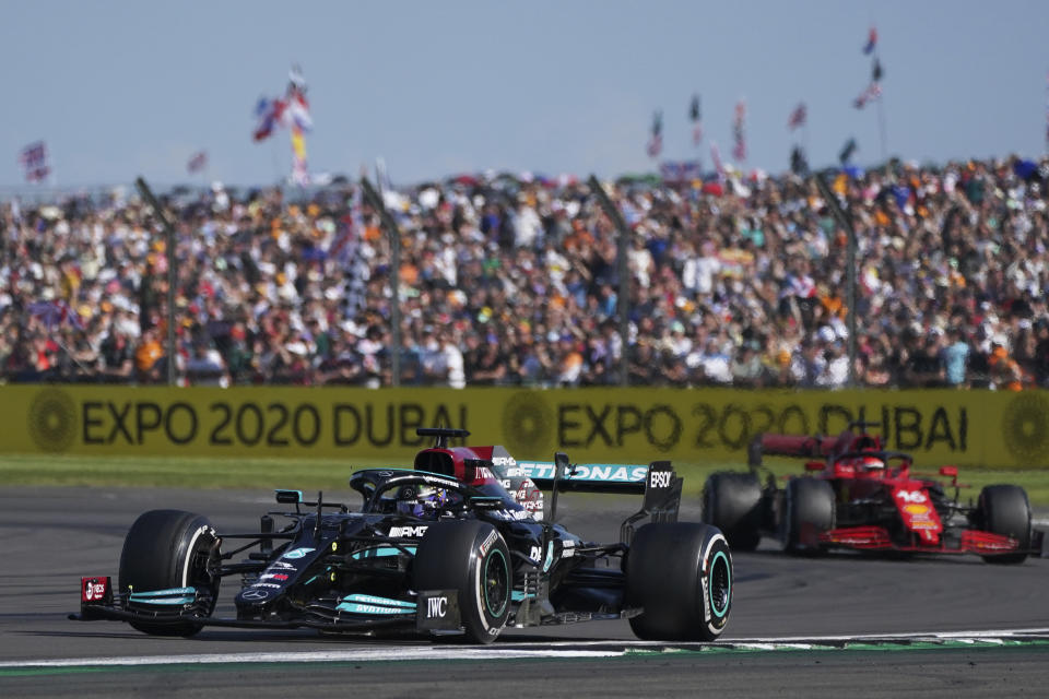 Mercedes driver Lewis Hamilton of Britain steers his car ahead of Ferrari driver Charles Leclerc of Monaco, right, during the British Formula One Grand Prix, at the Silverstone circuit, in Silverstone, England, Sunday, July 18, 2021. (AP Photo/Jon Super)