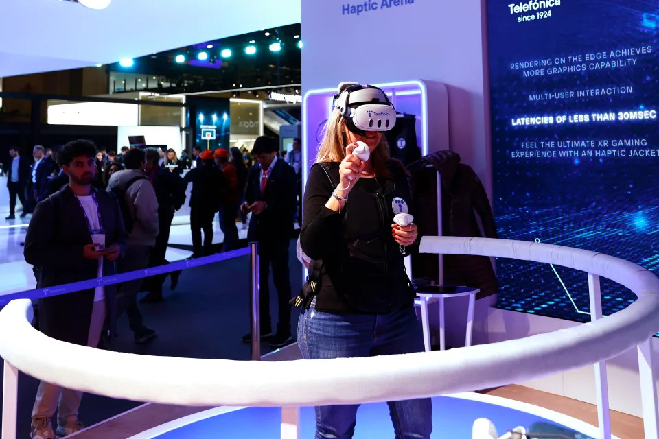 A woman is playing a virtual game of tennis using the Meta Quest 3, a virtual reality (VR) headset developed by Reality Labs, a division of Meta Platforms, at the Telefonica pavilion during the Mobile World Congress in Barcelona, Spain, on April 2, 2024. (Photo by Joan Cros/NurPhoto via Getty Images)