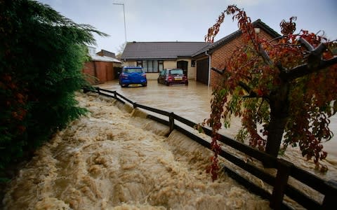 Homes are severely flooded as raging flood water rises in the village of Whiston near Sheffield - Credit: SWNS&nbsp;