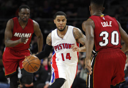 Detroit's D.J. Augustin drives against Miami's Norris Cole as Luol Deng trails the play. (Raj Mehta-USA TODAY Sports)