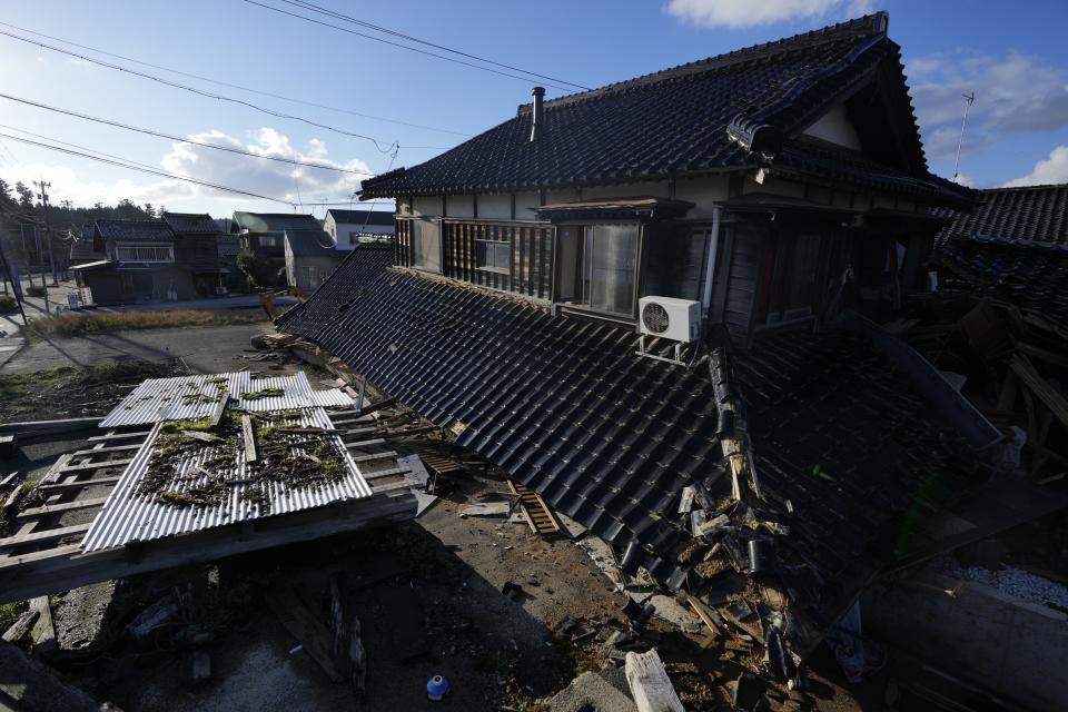 A collapsed house damaged by powerful earthquake are seen in Anamizu in the Noto peninsula facing the Sea of Japan, northwest of Tokyo, Thursday, Jan. 4, 2024. More soldiers have been ordered to bolster the rescue operations Thursday, providing those in need with drinking water, hot meals and setting up bathing facilities after a magnitude 7.6 quake hit Ishikawa Prefecture and nearby regions Monday. (AP Photo/Hiro Komae)