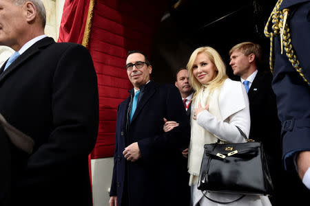 FILE PHOTO: US Treasury Secretary nominee Stephen Mnuchin and fiancee Louise Linton arrive for the Presidential Inauguration of Donald Trump at the US Capitol in Washington, U.S., January 20, 2017, . REUTERS/Saul Loeb/Pool/File Photo