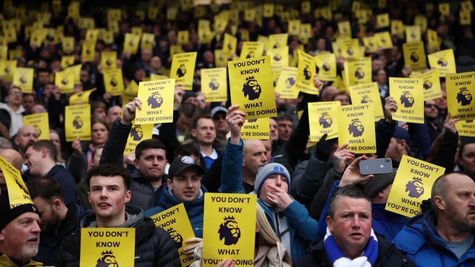 Everton fans hold up a sign in protest of the Premier League's decision to penalize the club for breaching financial regulations. - Phil Noble/Reuters