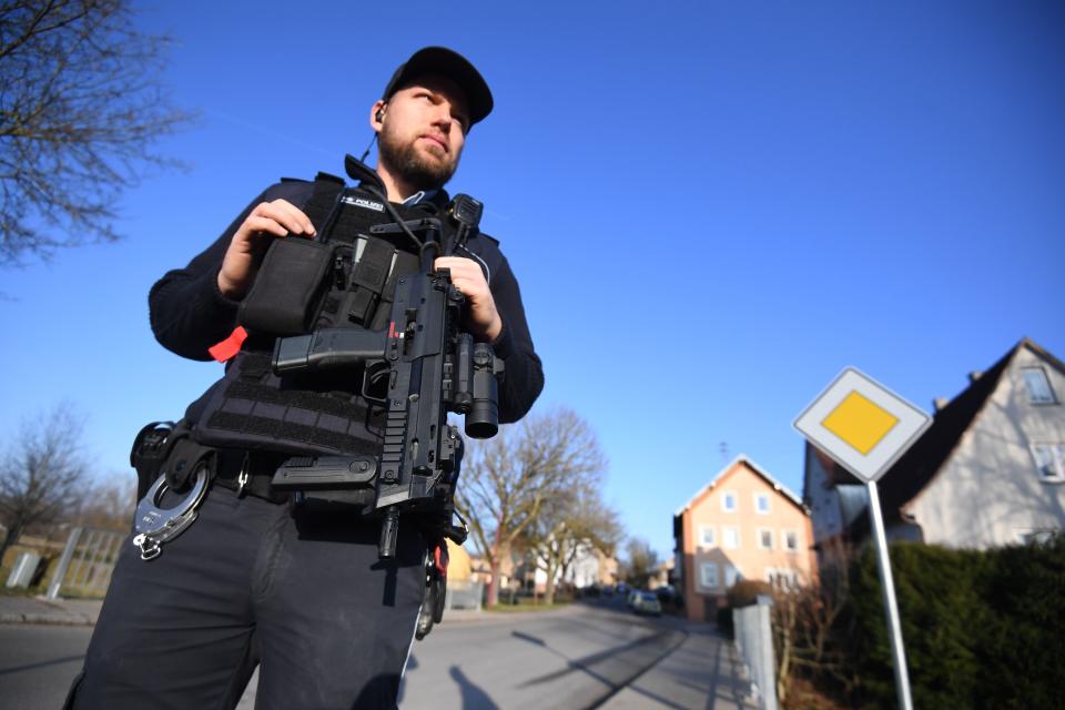 A policeman secures the area close to a house where a shooter, believed to have a personal motive, launched an assault on January 24, 2020 in the town of Rot am See in southwestern Germany. - Six people have been killed and two seriously injured in the shooting, police said. A man with a personal connection to the victims had been arrested, a police spokesman told AFP. (Photo by Marijan Murat / DPA / AFP) / Germany OUT (Photo by MARIJAN MURAT/DPA/AFP via Getty Images)