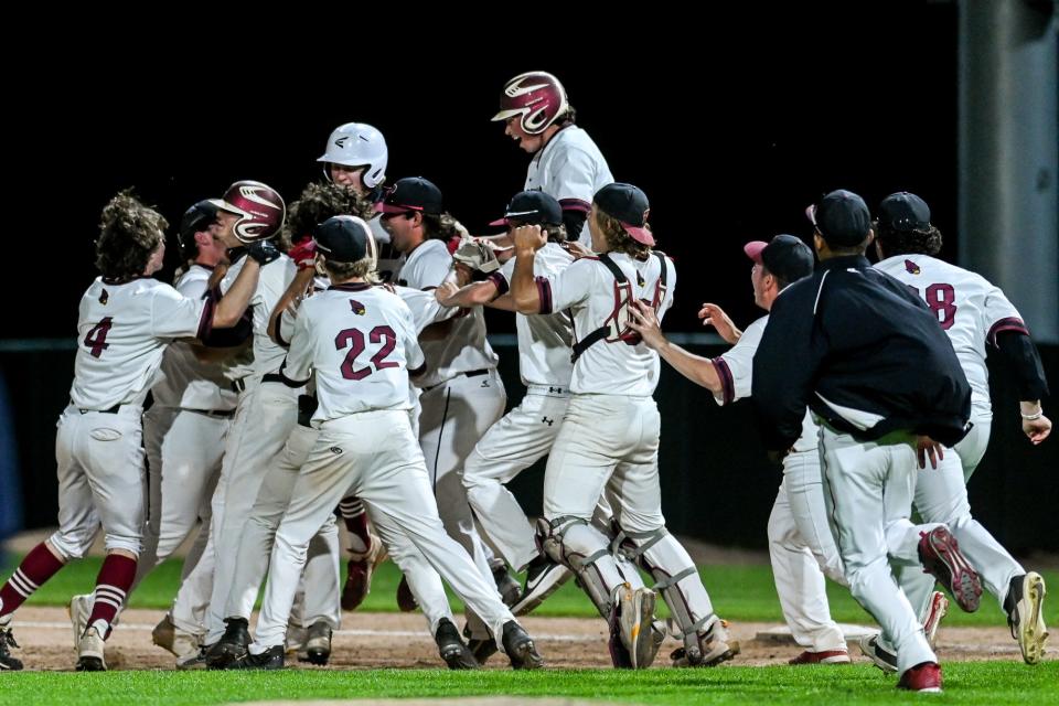 Portland celebrates after beating Grand Ledge on Tuesday, May 24, 2022, at McLane Stadium on the MSU campus in East Lansing.