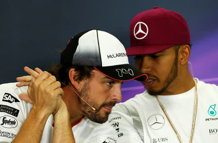 Formula One - Spanish Grand Prix - Barcelona-Catalunya racetrack, Montmelo, Spain - 12/5/16 McLaren's F1 driver Fernando Alonso (L) speaks to Mercedes's Lewis Hamilton during a news conference ahead of the Spanish Grand Prix. REUTERS/Albert Gea