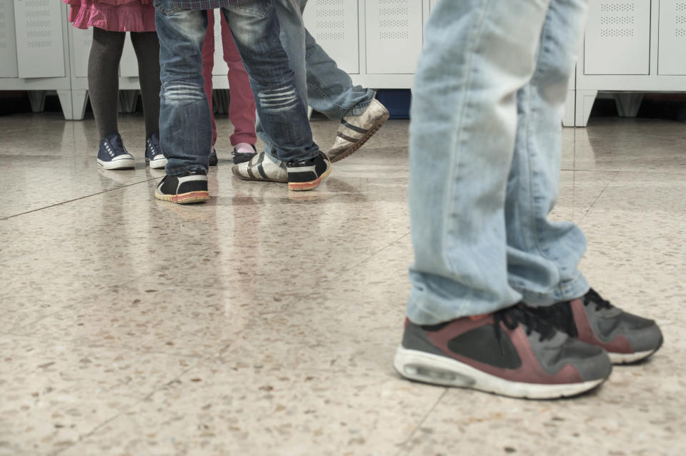 Pairs of feet in a hallway