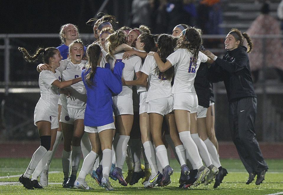 The Olentangy Orange girls soccer team celebrates its 1-0 win over Olentangy Berlin in a Division I regional semifinal Nov. 1 at Big Walnut.