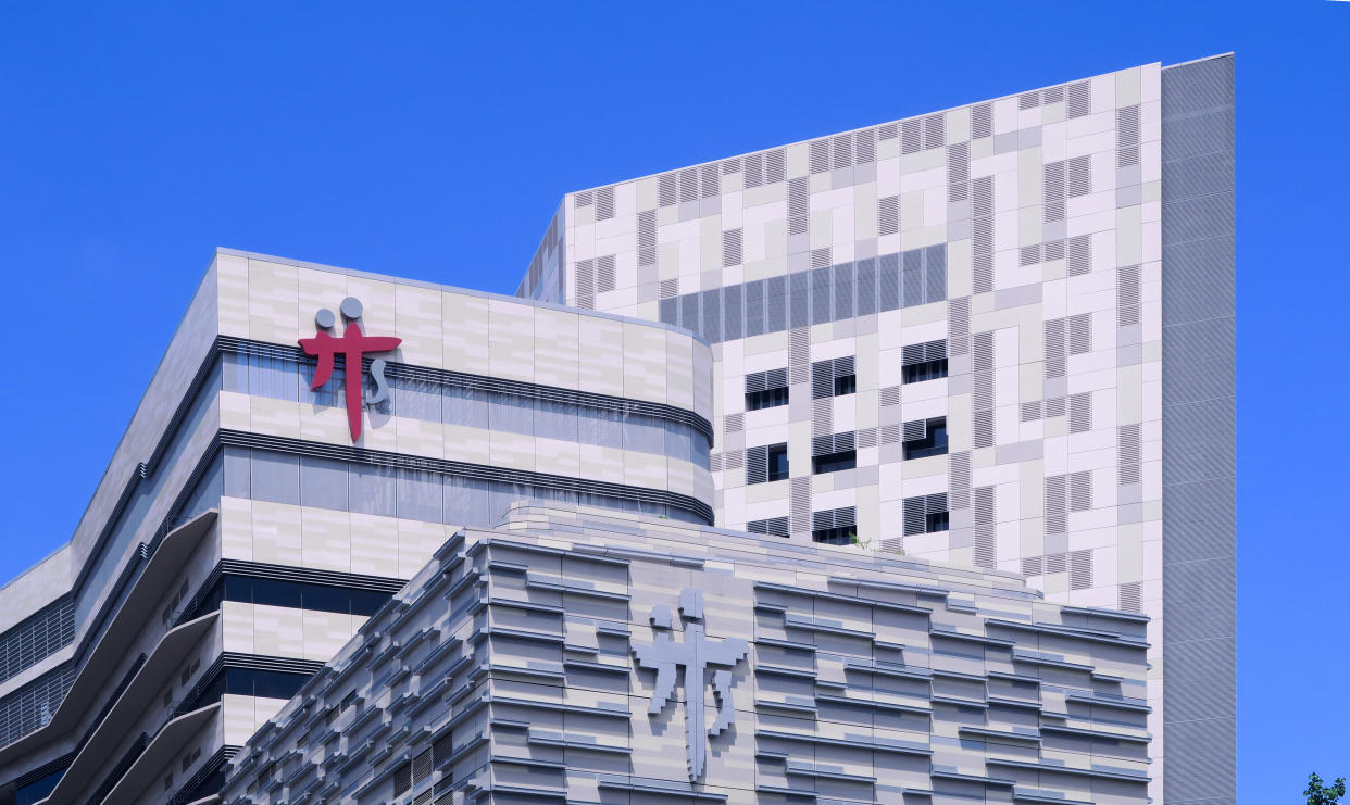 Singapore Jun2020 Covid-19. Singapore Tan Tock Seng hospital building exterior on a sunny day with clear blur sky; building sign signage