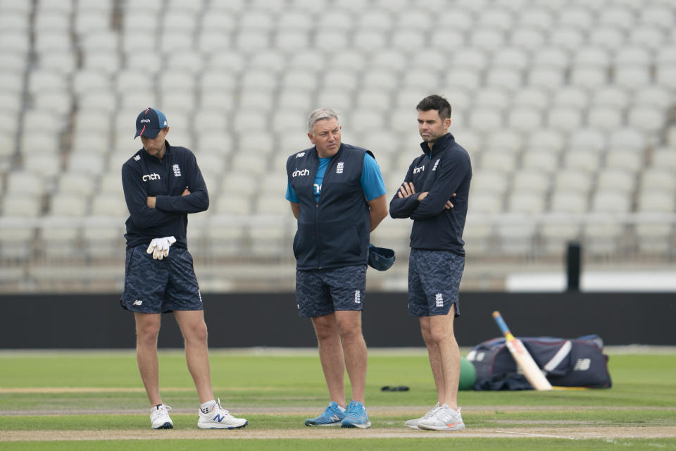 England's captain Joe Root, left, coach Chris Silverwood, center, and bowler James Anderson look at the pitch during a nets session before the 5th Test cricket match between England and India at Old Trafford cricket ground in Manchester, England, Thursday, Sept. 9, 2021. (AP Photo/Jon Super)