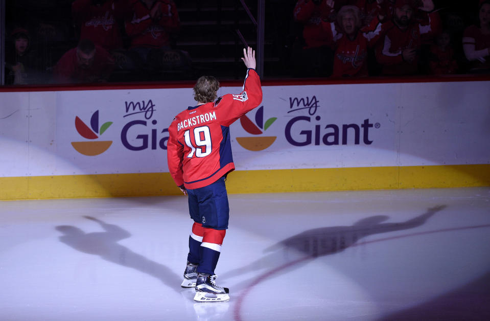 Washington Capitals center Nicklas Backstrom (19), of Sweden, waves to the crowd before an NHL hockey game against the Philadelphia Flyers, Sunday, Jan. 15, 2017, in Washington. Backstrom was honored for being the first player in franchise history to record 500 assists. (AP Photo/Nick Wass)