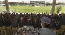 Pakistani policmen gather for a rehearsal of security arrangements for the Zimbabwe team outside the Gaddafi Cricket Stadium in Lahore on May 16, 2015