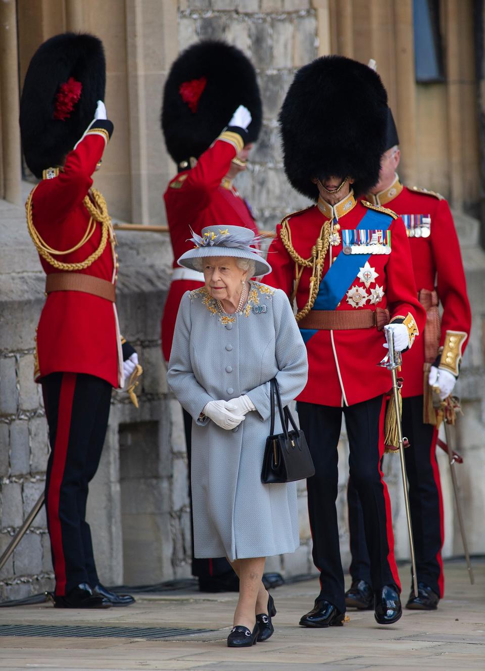 WINDSOR, ENGLAND - JUNE 12:  Queen Elizabeth II attends a military ceremony in the Quadrangle of Windsor Castle to mark her Official Birthday on June 12, 2020 at Windsor Castle on June 12, 2021 in Windsor, England. Trooping of the Colour has marked the Official Birthday of the Sovereign for over 260 years and it has been agreed once again that in line with government advice The Queen’s Birthday Parade, also known as Trooping the Colour, will not go ahead in its traditional form. This years parade is formed by soldiers who have played an integral role in the NHS’ COVID-19 response, as well as those who have been serving on military operations overseas. (Photo by Eddie Mulholland - WPA Pool/Getty Images)