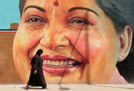 A woman walks past a portrait of J. Jayalalithaa, Chief Minister of the southern state of Tamil Nadu, in Chennai, India, March 13, 2012. REUTERS/Babu/File Photo