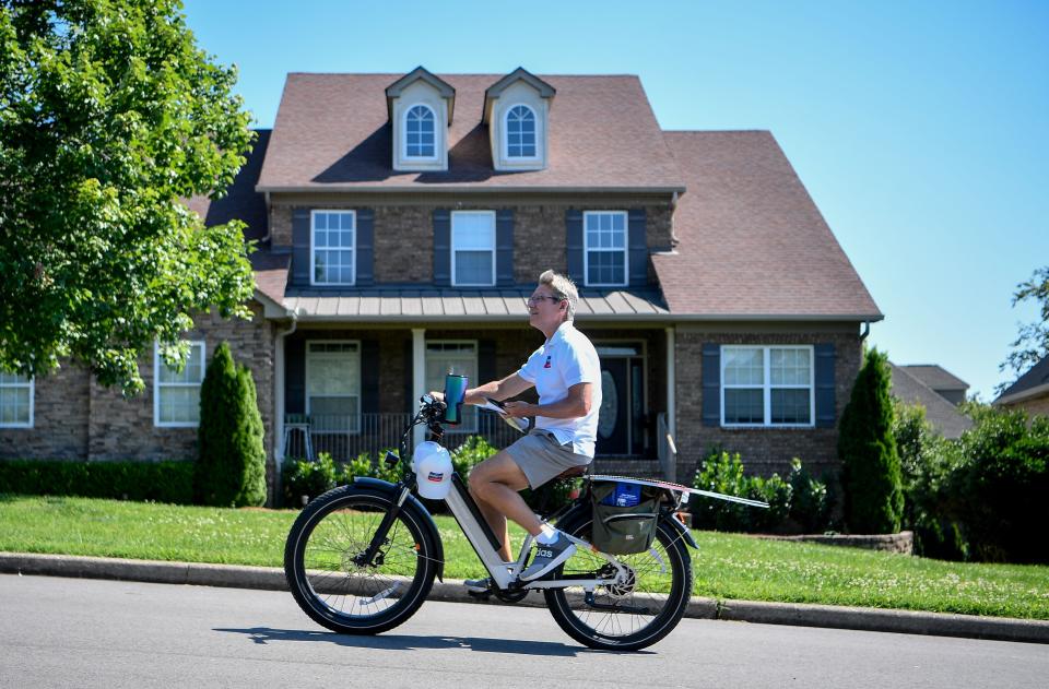 Chris Spencer, a Republican candidate for Tennessee Senate District 18, rides his electric bike in the Somerset Downs neighborhood in Hendersonville, Tenn., Thursday, June 13, 2024.