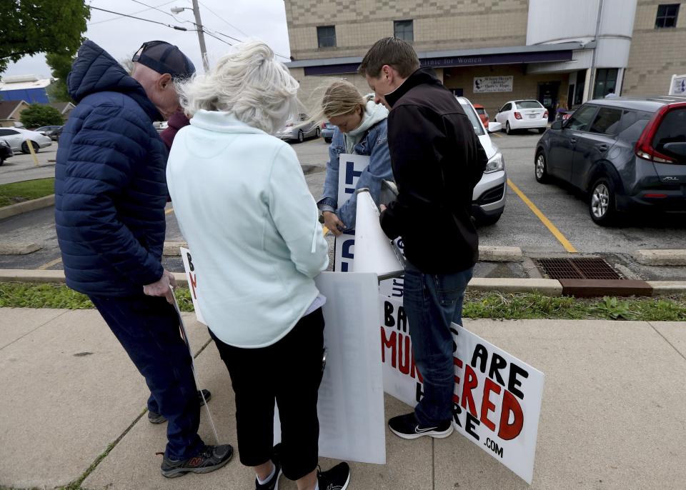 FILE - Anti-abortion protesters from Christ Fellowship Bible Church in Brentwood, Mo., pray on Tuesday, May 3, 2022, outside the Hope Clinic in Granite City, Ill. Metro East clinics are forecasting a surge in out-of-state patients if the Supreme Court indeed overturns federal abortion protections. (Laurie Skrivan/St. Louis Post-Dispatch via AP, File)