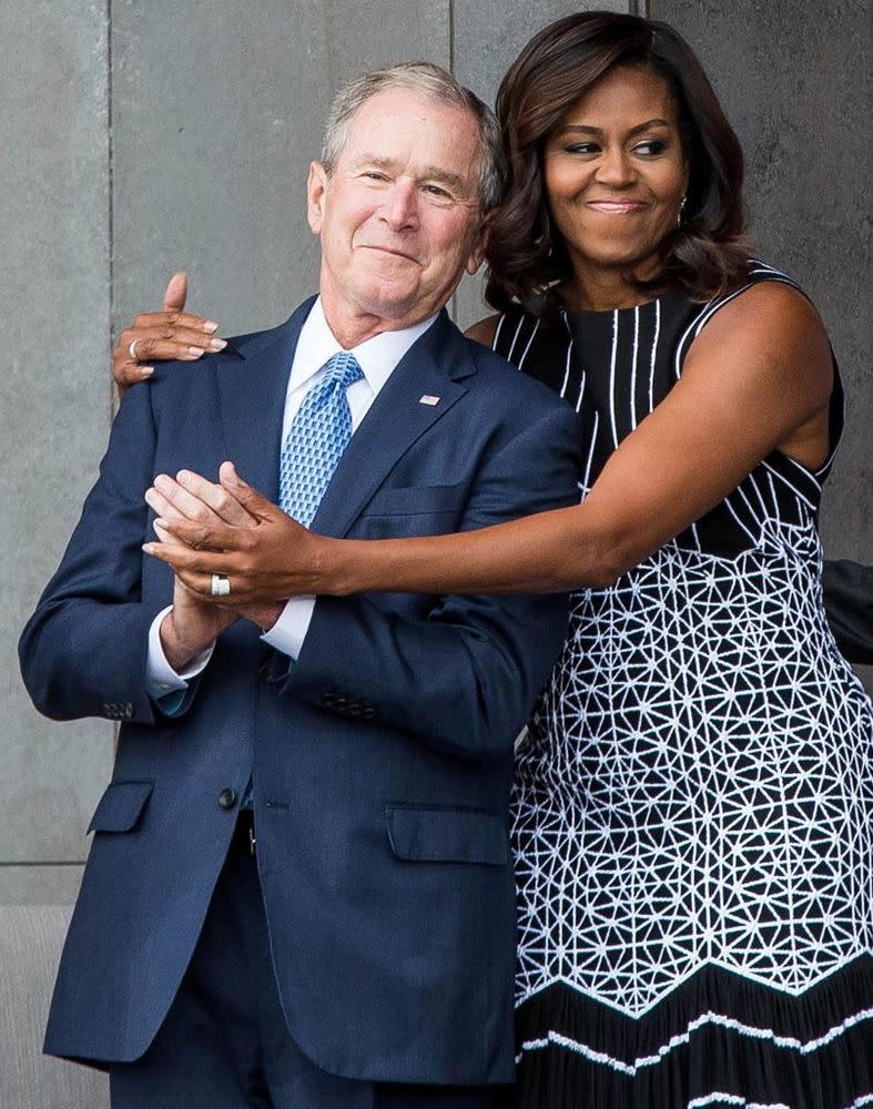 From left: Former President George W. Bush is hugged by former First Lady Michelle Obama in 2016