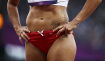 The tattoo of Lebanon's Gretta Taslakian is seen during her women's 200m round 1 heat at the London 2012 Olympic Games at the Olympic Stadium August 6, 2012. REUTERS/Lucy Nicholson (BRITAIN - Tags: OLYMPICS SPORT ATHLETICS) 