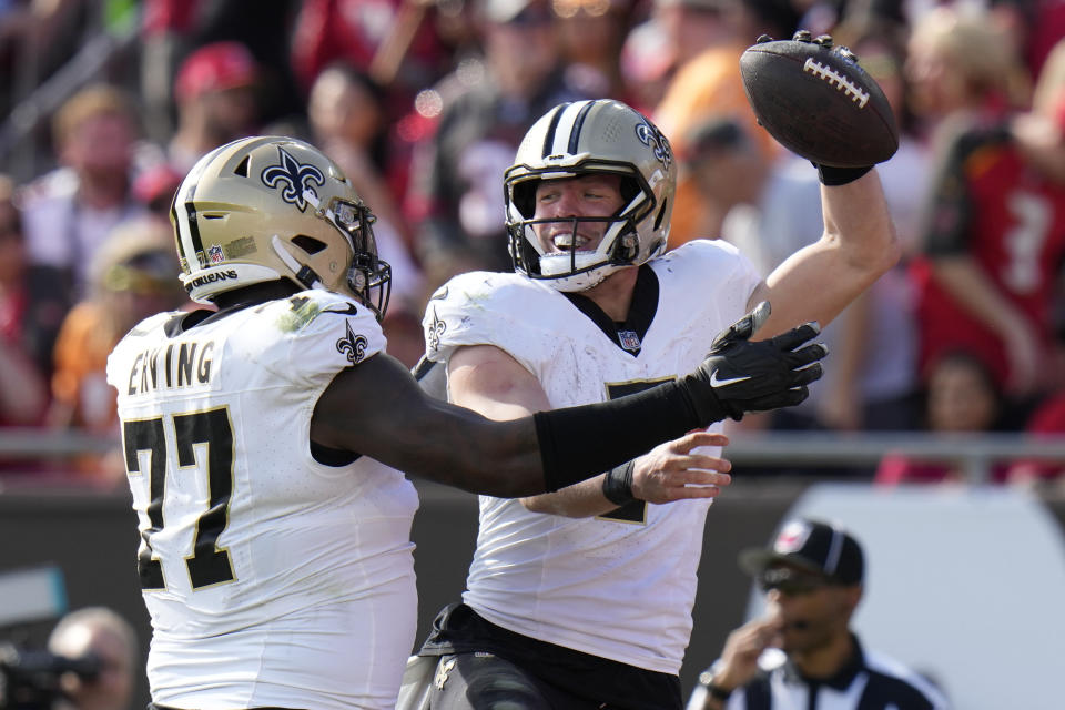 New Orleans Saints Taysom Hill celebrates his touchdown repletion with guard Cameron Erving (77) in the first half of an NFL football game against the Tampa Bay Buccaneers in Tampa, Fla., Sunday, Dec. 31, 2023. (AP Photo/Chris O'Meara)