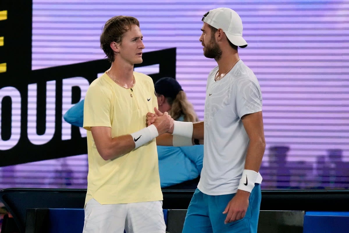 Karen Khachanov, right, shakes hands with Sebastian Korda following his retirement (Dita Alangkara/AP) (AP)