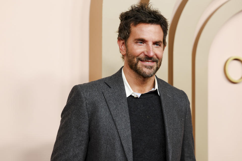 Bradley smiling in a casual blazer over a collared shirt at an event