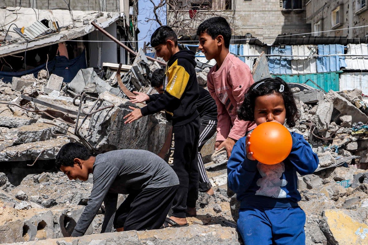 Palestinian children play amongst the rubble in Rafah (AFP)
