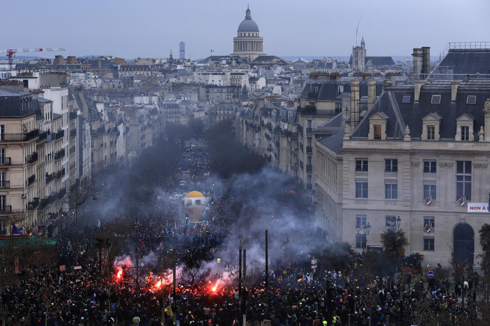 Protesters march, with the Pantheon monument in background, during a demonstration in Paris, Tuesday, March 7, 2023. Hundreds of thousands of demonstrators across France took part Tuesday in a new round of protests and strikes against the government's plan to raise the retirement age to 64, in what unions hope will be their biggest show of force against the proposal. (AP Photo/Aurelien Morissard)