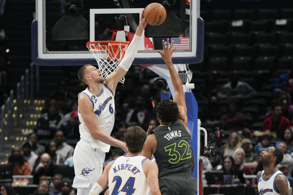 Washington Wizards center Kristaps Porzingis (6) blocks the shot by Minnesota Timberwolves center Karl-Anthony Towns (32) during the first half of an NBA basketball game, Monday, Nov. 28, 2022, in Washington. (AP Photo/Jess Rapfogel)