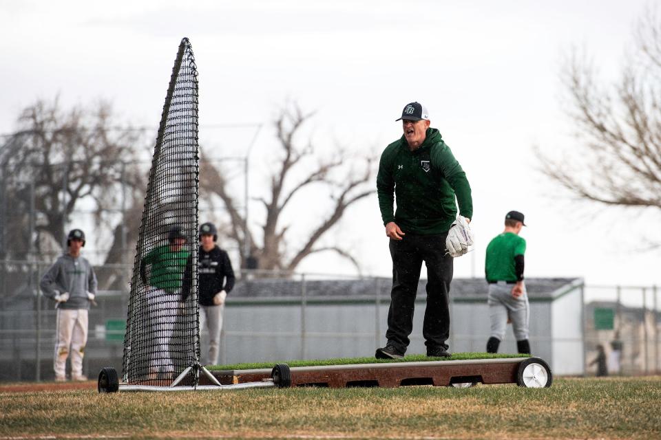 Fossil Ridge head baseball coach Marc Wagner instructs the team during a practice on April 10 at Fossil Ridge High School in Fort Collins.