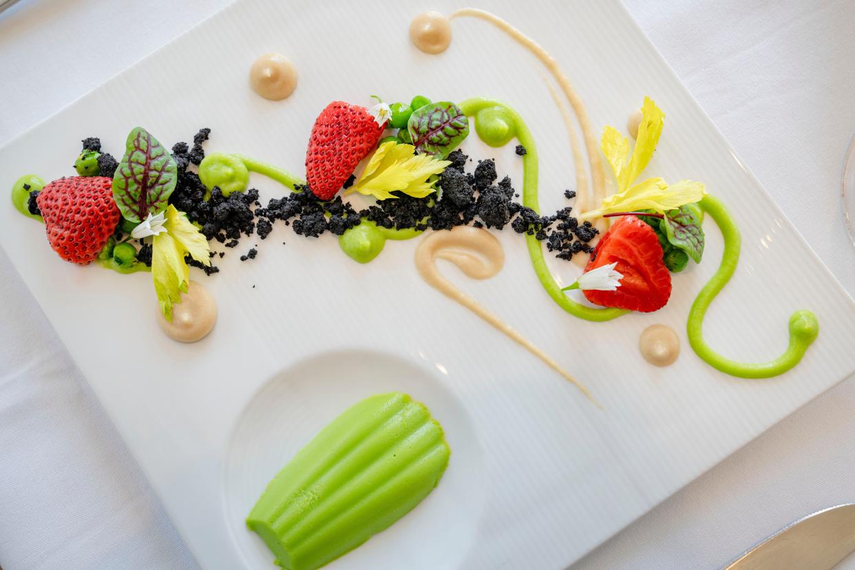 Spring pea panna cotta served with grilled maitake mushrooms, pickled strawberries, fennel, and earth tone crumble at Oak Park.