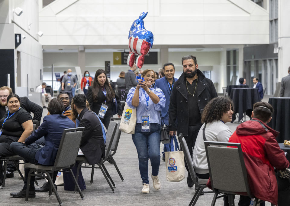 Delegate Margarita Darrett-Quiroz walks with a donkey balloon through the SAFE Credit Union Convention Center foyer at the 2023 California Democratic Party state endorsement convention on Friday, Nov. 17, 2023, in Sacramento. (Lezlie Sterling/The Sacramento Bee via AP)