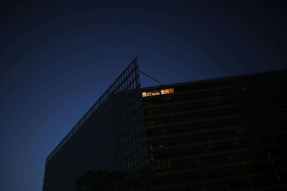 A light is on at the EU Charlemagne building during a partial lockdown ordered by Belgium government in Brussels, Monday, March 23, 2020. For some people the COVID-19 coronavirus causes mild or moderate symptoms, but for some it causes severe illness. (AP Photo/Francisco Seco)