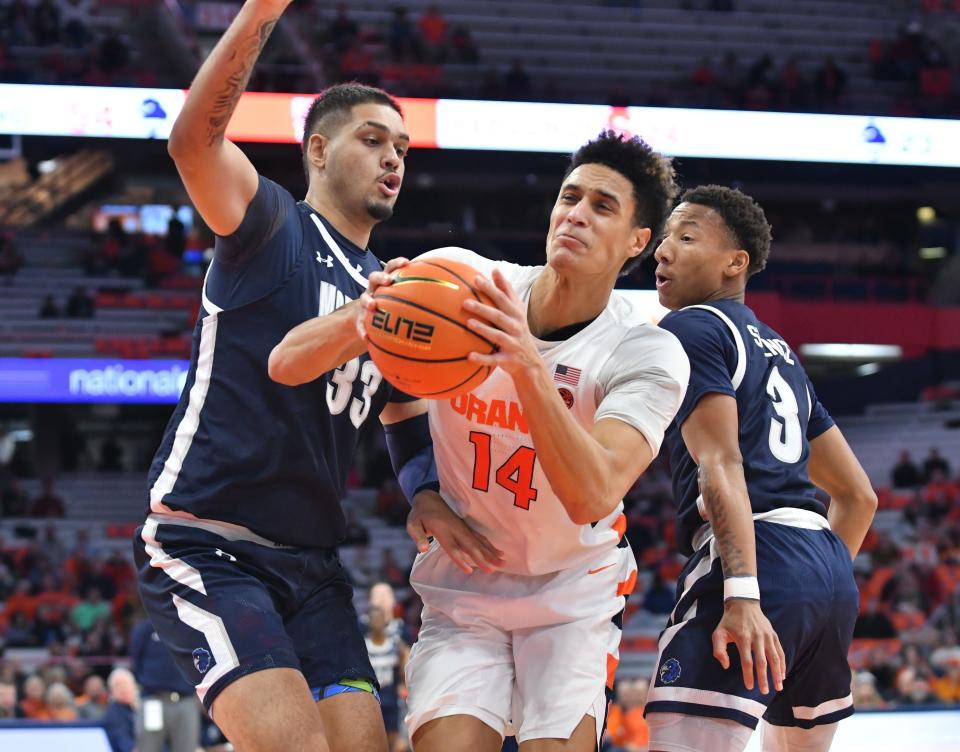 Syracuse Orange center Jesse Edwards (14) moves between Monmouth Hawks center Amaan Sandhu (33) and guard Jakari Spence (3) in the second half at JMA Wireless Dome.