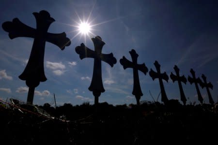 FILE PHOTO: Crosses are seen placed at a memorial in memory of the victims killed in the shooting at the First Baptist Church of Sutherland Springs, Texas, U.S., November 7, 2017. REUTERS/Jonathan Bachman/File Photo