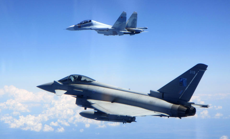 CAPTION CORRECTS AIRCRAFT NAME - In this photo taken on Saturday, June 15, 2019, a Royal Air Force Typhoon jet, bottom, flies by a Su-30 Flanker fighter. Two Royal Air Force jets deployed in Estonia have been scrambled twice in recent days, bringing the number of intercepts of Russian aircraft to eight since taking over the Baltic Air Policing mission in early May. The Typhoon jets were alerted Friday to intercept a Russian Su-30 Flanker fighter, and passed a military transport craft as it was escorting the fighter over the Baltic Sea. In a second incident on Saturday, RAF crews intercepted a Su-30 Flanker fighter and an Ilyushin Il-76 Candid transport aircraft that was traveling north from the Russian enclave of Kaliningrad toward Estonian and Finnish airspace. (UK Ministry of Defence via AP)