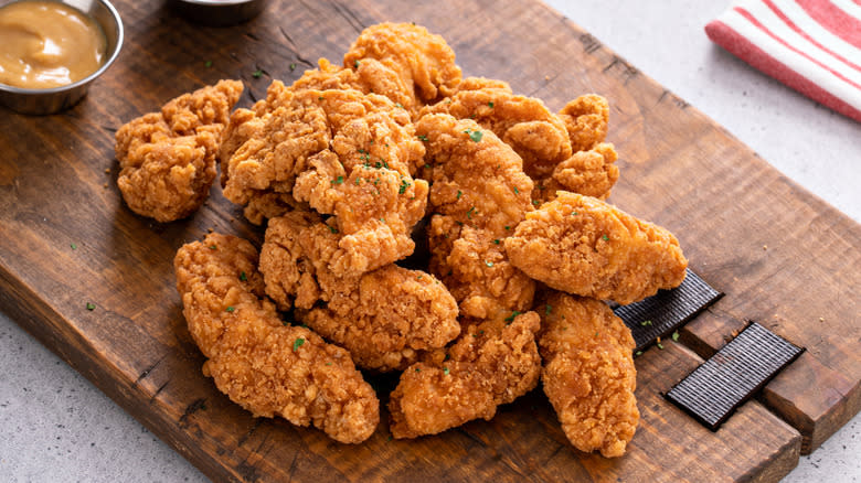 chicken tenders on wooden platter