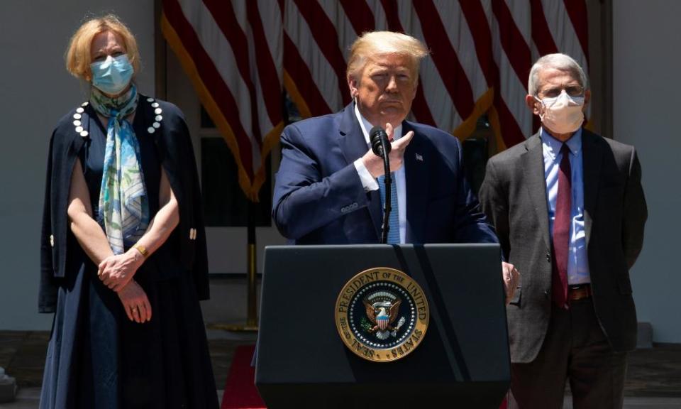 Drs Deborah Birx and Anthony Fauci wear face masks as they listen to Donald Trump speak in the Rose Garden of the White House on 15 May.