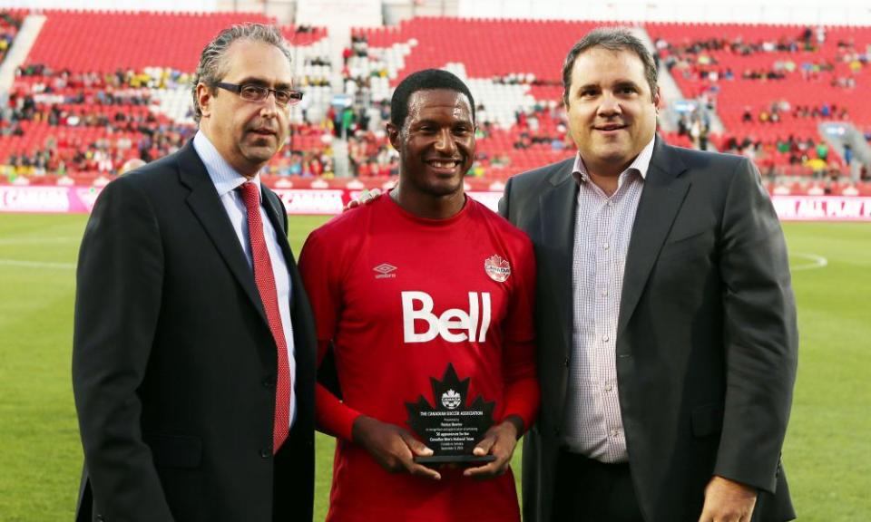 Canada Soccer officials Peter Montopoli, left, and Victor Montagliani, right, stand with Patrice Bernier before a 2014 friendly between Canada and Jamaica at Toronto’s BMO Field.