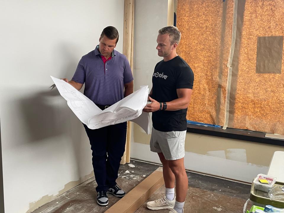 From left, co-owners Chris Triplett and Michael Foguth review plans for a new Everbowl location in downtown Brighton on Thursday, Sept. 7, 2023.