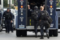 Police work near the scene of a shooting Saturday, Aug. 29, 2020, in St. Louis. The St. Louis Police Department says two of their officers have been shot and a suspect is believed to be barricaded in a house nearby. (AP Photo/Jeff Roberson)